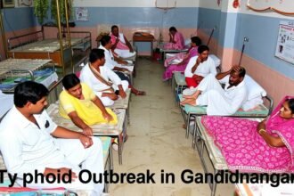 A photo of a hospital ward with patients being treated for typhoid, with a background of a polluted water source and a caption "Typhoid Outbreak in Gandhinagar"