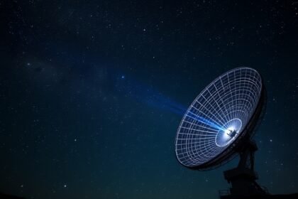 A high-resolution image of the Giant Metrewave Radio Telescope (GMRT) with a pulsar visible in the night sky, surrounded by stars and galaxies, with a subtle glow effect to represent the radio waves being detected.