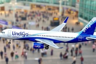 An image of the Airbus A321XLR aircraft in IndiGo livery, with a blurred background of a bustling airport, highlighting the aircraft's distinctive features and IndiGo's branding.