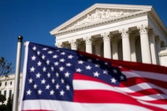 A photo of the US Supreme Court building with a flag of the United States in the foreground, symbolizing the balance of power between the judiciary and the executive branch in trade policy decisions.