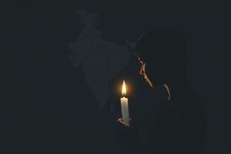 A somber illustration of a person holding a candle with a faint image of the Indian map in the background, highlighting the struggles of northeast students in India