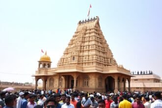 A photograph of the Somnath Temple in Gujarat, India, with a crowd of people in the foreground and the temple's majestic structure in the background, symbolizing the blend of history, culture, and spirituality.