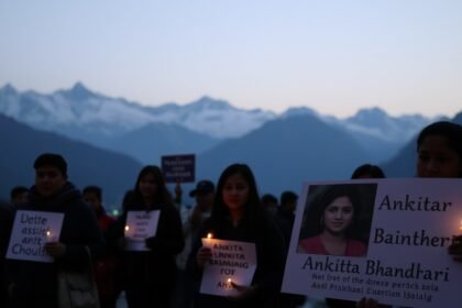 A somber image of a candlelight vigil for Ankita Bhandari, with people holding placards demanding justice, set against the backdrop of the Himalayas in Uttarakhand.