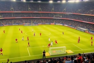 A photo of a football stadium in India with players in action, highlighting the excitement and energy of the Indian Super League